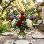 patriotic flower arrangements: A luxury red white and blue floral centerpiece featuring roses and hydrangeas on a garden table.